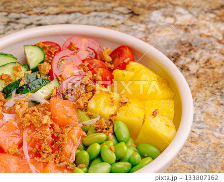 Vibrant, fresh bowl of fruits and veggies on a stone surface 133807162