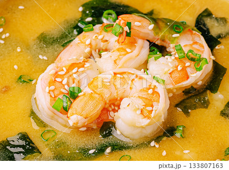 Fresh shrimp and seaweed in a savory broth with scallions for flavor Fresh shrimp and seaweed in a savory broth with scallions for flavor 133807163