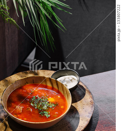 Delicious soup served in a rustic bowl at a cozy cafe during lunch time 133807222