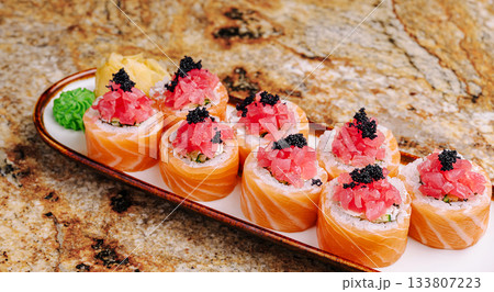 Delicious sushi platter featuring colorful rolls and fresh fish Delicious sushi platter featuring colorful rolls and fresh fish 133807223