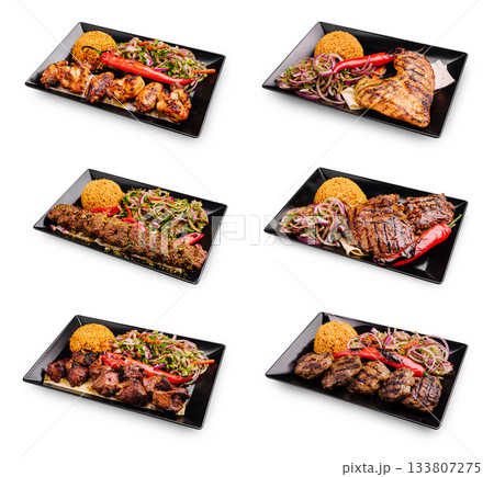 Delicious grilled dishes served with rice and vegetables at a vibrant eatery Delicious grilled dishes served with rice and vegetables at a vibrant eatery 133807275