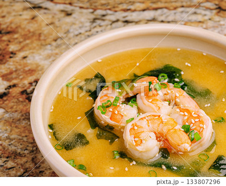 Delicious shrimp soup with seaweed served in a white bowl Delicious shrimp soup with seaweed served in a white bowl 133807296