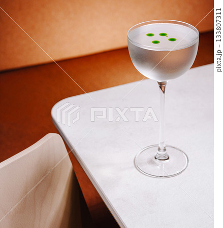 Elegant cocktail on a table with unique garnish in a modern setting Elegant cocktail on a table with unique garnish in a modern setting 133807311