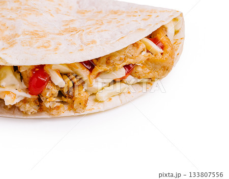 Delicious chicken wrap with fresh ingredients and spices for a tasty meal Delicious chicken wrap with fresh ingredients and spices for a tasty meal 133807556