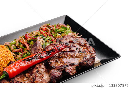 Delicious grilled steak served with roasted vegetables and lentils 133807573