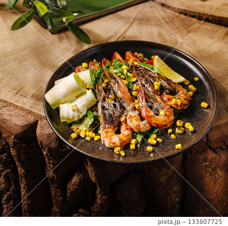 Delicious shrimp dish served with fresh vegetables and corn Delicious shrimp dish served with fresh vegetables and corn 133807725