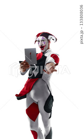 Jester offering Joker card forward with expressive dramatic gesture 133808036