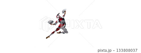 Wide-frame jester leap holding large playing cards in dramatic arc. Banner 133808037