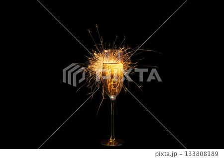 Champagne Glass with Sparkler Explosion on Black Background 133808189
