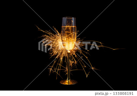 Champagne Glass with Sparkler Explosion on Black Background 133808191