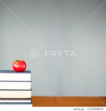 Red apple on pile of books in classroom 133808848