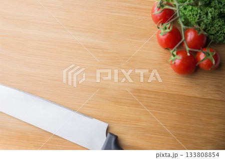 Tomatoes and parsley with kitchen knife 133808854