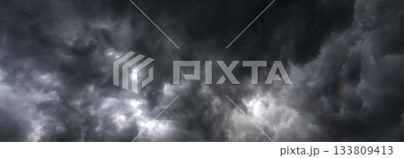 Banner Dramatic dark storm clouds black sky background. Dark thunderstorm clouds rainny season. Panorama Meteorology danger windstorm disasters climate. Dark cloudscape storm cloud with copy space. 133809413