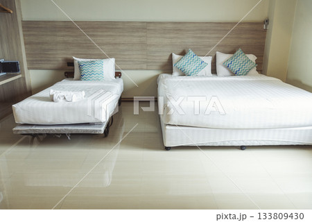 Blur background bedroom home interior in cozy decoration room. Clean soft bed stylish decor relax dorm with copy space. Modern apartment white light trendy style. Blurred background defocused indoors 133809430
