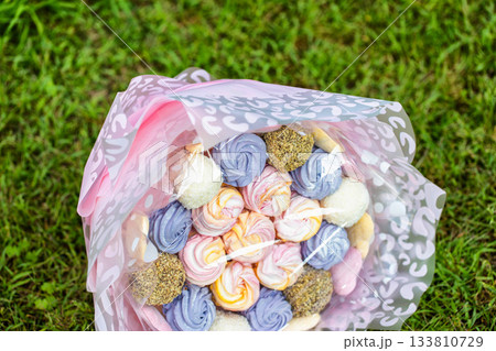 Gift set of marshmallows and sweets on green grass, close-up. Sweet food 133810729