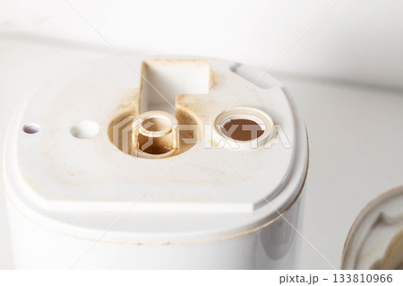 Unpleasant smell, rust and scale from water in the humidifier, white background, close-up 133810966