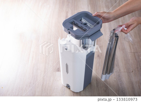 Assembling a bucket with a modern mop with a wringer for easy cleaning. Copy space for text, rinsing the mop 133810973
