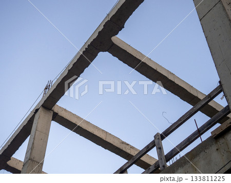 Structure made of concrete piles. Frame of a house under construction. Stone beams. Structure made of concrete piles. Frame of a house under construction. Stone beams. 133811225