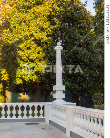 White decorative column in the park. Park decoration. Architecture of the resort town White decorative column in the park. Park decoration. Architecture of the resort town 133811231