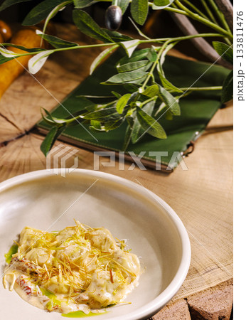Delicious dish served on wooden table with leafy decor in cozy setting Delicious dish served on wooden table with leafy decor in cozy setting 133811476