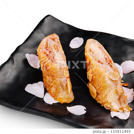 Dessert featuring almond pastries with pink flower petals for decoration Dessert featuring almond pastries with pink flower petals for decoration 133811493