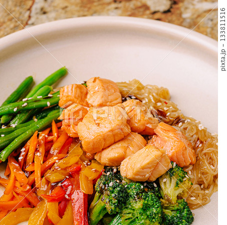 Healthy salmon dish with fresh vegetables in a clean setting 133811516