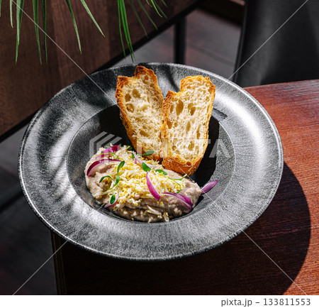 Delicious dish served with toasted bread in a modern dining setting Delicious dish served with toasted bread in a modern dining setting 133811553