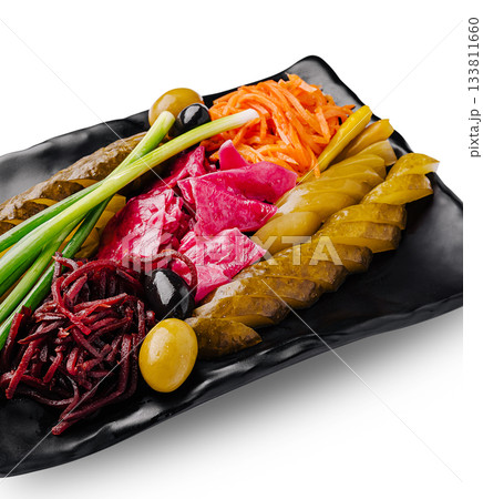 Variety of pickled vegetables and meats on a black plate Variety of pickled vegetables and meats on a black plate 133811660