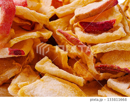 Dried apple slices ready for snacking in a clear container 133811668