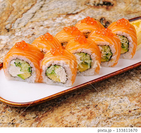 Colorful sushi rolls arranged neatly on a plate ready to be enjoyed Colorful sushi rolls arranged neatly on a plate ready to be enjoyed 133811670