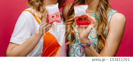 Friends enjoying colorful desserts at a vibrant party setting Friends enjoying colorful desserts at a vibrant party setting 133811701