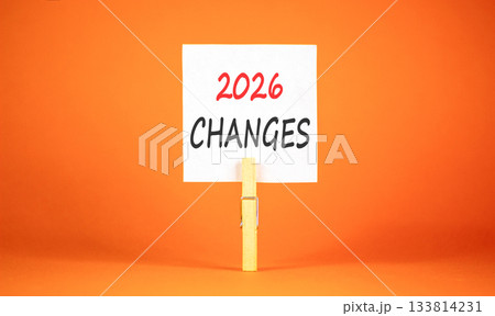 2026 Changes symbol. Concept words 2026 Changes on beautiful white paper on wooden clothespin. Beautiful orange background. Business and 2026 changes concept. Copy space. 133814231