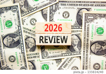 2026 Review symbol. Concept words 2026 Review on beautiful wooden blocks. Beautiful dollar bills background. Dollar bills. Business and 2026 review concept. Copy space. 133814240