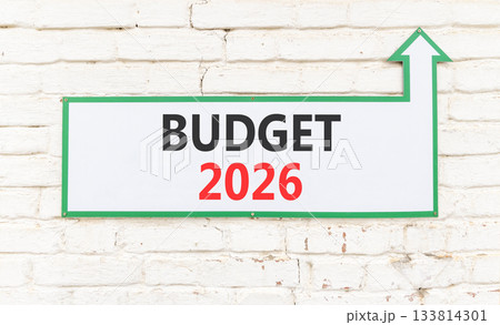 Budget 2026 symbol. Concept words Budget 2026 on beautiful white sign with arrow. Beautiful old white brick wall background. Business and budget 2026 concept. Copy space. 133814301