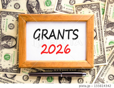 Grants 2026 symbol. Concept words Grants 2026 on beautiful wooden picture frame. Beautiful dollar bills background. Black pen. Dollar bills. Business and grants 2026 concept. Copy space. Grants 2026 symbol. Concept words Grants 2026 on beautiful wooden picture frame. Beautiful dollar bills background. Black pen. Dollar bills. Business and grants 2026 concept. Copy space. 133814342