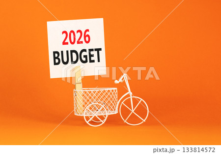 2026 Budget symbol. Concept words 2026 Budget on beautiful white paper on wooden clothespin. Beautiful orange background. Beautiful miniature bicycle. Business and 2026 budget concept. Copy space. 133814572