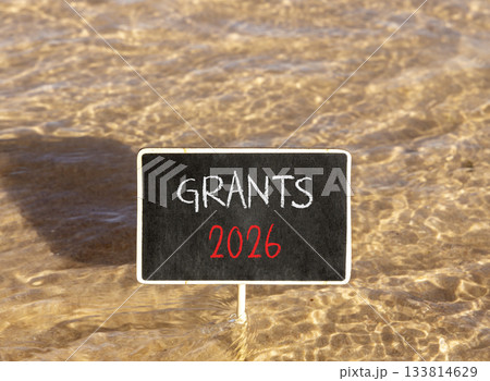 Grants 2026 symbol. Concept words Grants 2026 on beautiful black blackboard. Beautiful Red sea water background. Business and grants 2026 concept. Copy space. 133814629