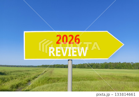 2026 Review symbol. Concept words 2026 Review on beautiful yellow road sign. Beautiful green grass field forest and blue sky background. Business and 2026 review concept. Copy space. 2026 Review symbol. Concept words 2026 Review on beautiful yellow road sign. Beautiful green grass field forest and blue sky background. Business and 2026 review concept. Copy space. 133814661