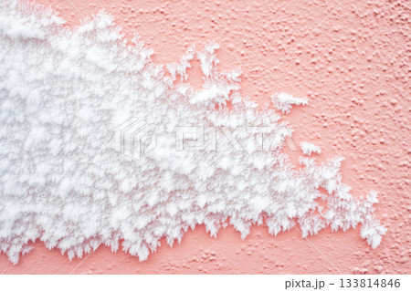 Beautiful frost covers part of a pink wall, showcasing unique patterns that glisten in the cold light of winter Beautiful frost covers part of a pink wall, showcasing unique patterns that glisten in the cold light of winter 133814846