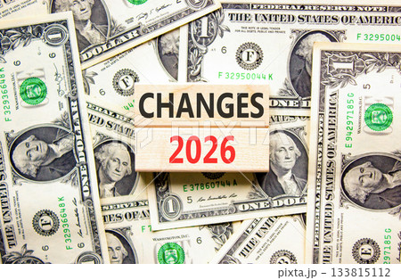 Changes 2026 symbol. Concept words Changes 2026 on beautiful wooden blocks. Beautiful dollar bills background. Dollar bills. Business and changes 2026 concept. Copy space. 133815112