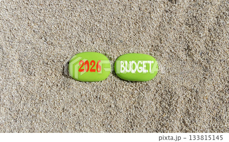 2026 Budget symbol. Concept words 2026 Budget on beautiful green stones on sand beach. Beautiful sand beach background. Business and 2026 budget concept. Copy space. 133815145