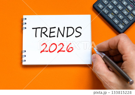 Trends 2026 new year symbol. Concept words Trends 2026 on beautiful white note. Black calculator. Beautiful orange background. Businessman's hand. Business and Trends 2026 new year concept. Copy space Trends 2026 new year symbol. Concept words Trends 2026 on beautiful white note. Black calculator. Beautiful orange background. Businessman's hand. Business and Trends 2026 new year concept. Copy space 133815228