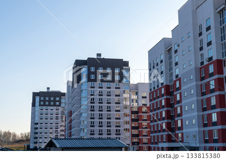 Modern high-rise apartment buildings featuring gray, white, and red facades 133815380