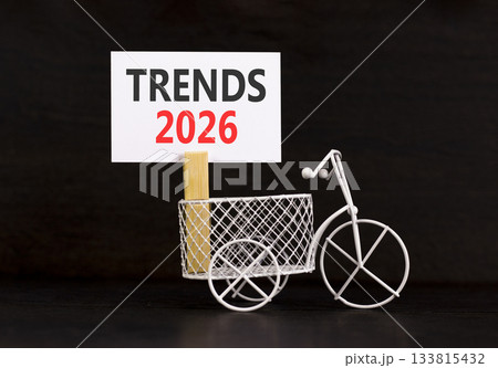 Trends 2026 symbol. Concept words Trends 2026 on beautiful white paper on wooden clothespin. Beautiful black background. Beautiful miniature bicycle. Business Trends 2026 new year concept. Copy space Trends 2026 symbol. Concept words Trends 2026 on beautiful white paper on wooden clothespin. Beautiful black background. Beautiful miniature bicycle. Business Trends 2026 new year concept. Copy space 133815432