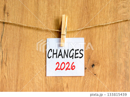 Changes 2026 symbol. Concept words Changes 2026 on beautiful white paper on wooden clothespin. Beautiful wooden background. Business and changes 2026 concept. Copy space. 133815439