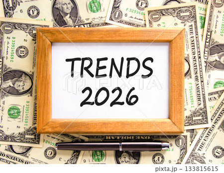 Trends 2026 new year symbol. Concept words Trends 2026 on beautiful wooden picture frame. Beautiful dollar bills background. Black pen. Dollar bills. Business Trends 2026 new year concept. Copy space. Trends 2026 new year symbol. Concept words Trends 2026 on beautiful wooden picture frame. Beautiful dollar bills background. Black pen. Dollar bills. Business Trends 2026 new year concept. Copy space. 133815615