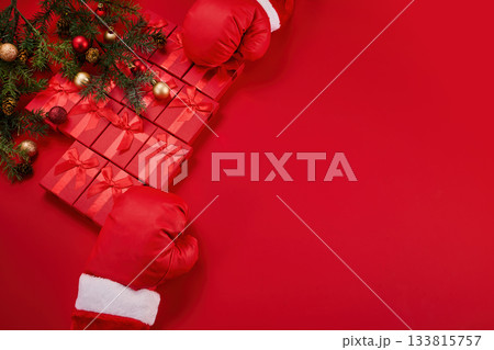 Boxing day. Santa gloves holding stacked red gift boxes Boxing day. Santa gloves holding stacked red gift boxes 133815757