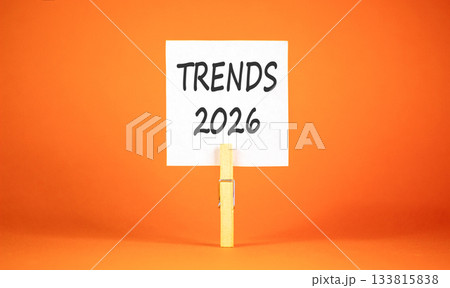 Trends 2026 new year symbol. Concept words Trends 2026 on beautiful white paper on wooden clothespin. Beautiful orange background. Business and Trends 2026 new year concept. Copy space. Trends 2026 new year symbol. Concept words Trends 2026 on beautiful white paper on wooden clothespin. Beautiful orange background. Business and Trends 2026 new year concept. Copy space. 133815838