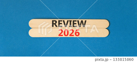 Review 2026 symbol. Concept words Review 2026 on beautiful wooden sticks. Beautiful blue paper background. Business and review 2026 concept. Copy space. Review 2026 symbol. Concept words Review 2026 on beautiful wooden sticks. Beautiful blue paper background. Business and review 2026 concept. Copy space. 133815860