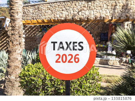 Taxes 2026 new year symbol. Concept words Taxes 2026 on beautiful white and red road sign. Beautiful palm trees palm-trees background. Business and taxes 2026 new year concept. Copy space 133815876